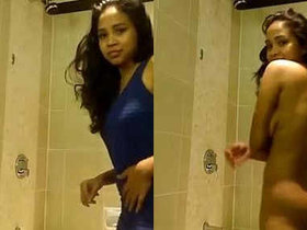 A young Indian woman undresses in her bathroom and gets captured on camera