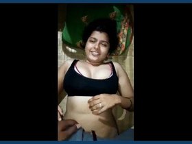 A handsome man pleases his lovely Indian wife by fondling her breasts