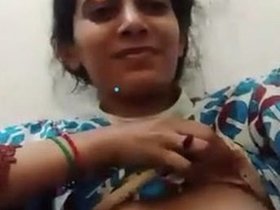 A charming girl displays her breasts on video call