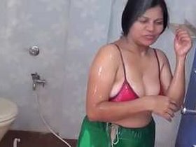 Indian aunt with large breasts takes a bath