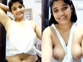 A seductive Indian woman displays her large breasts in a video labeled as bhabi.