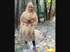 A charming Bengali woman entices and displays her attractive physique, including her intimate area.