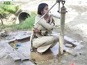 Young village girl taking a bath in a sari and caught on camera