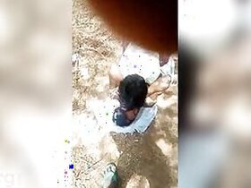 Guy lies on top of Desi girlfriend in front of the xxx cameraman in the open air