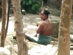 Indian aunt takes bath outdoors fully nude, caught on hidden camera
