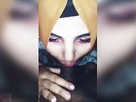 Attractive girl in a hijab pleases her boyfriend with a blowjob.