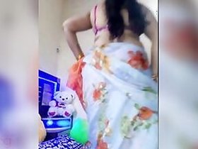 Desi takes off her sari a bit to expose her naked XXX assets at home